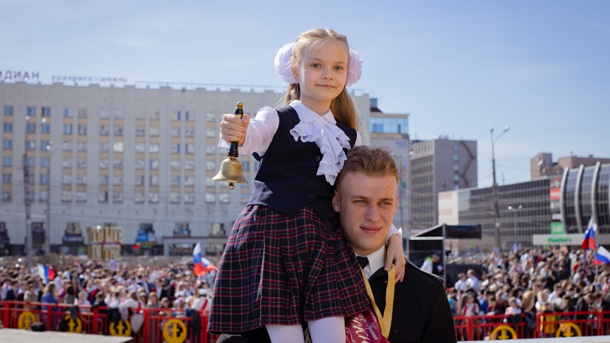 выпускник несет девочку на плече