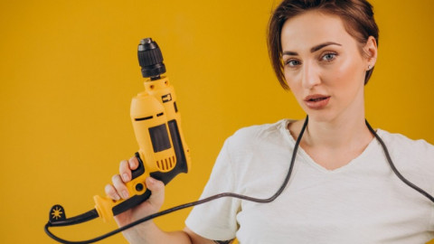 Женщина держит шуруповерт