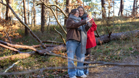 Две девушки делают селфи во время прогулки.